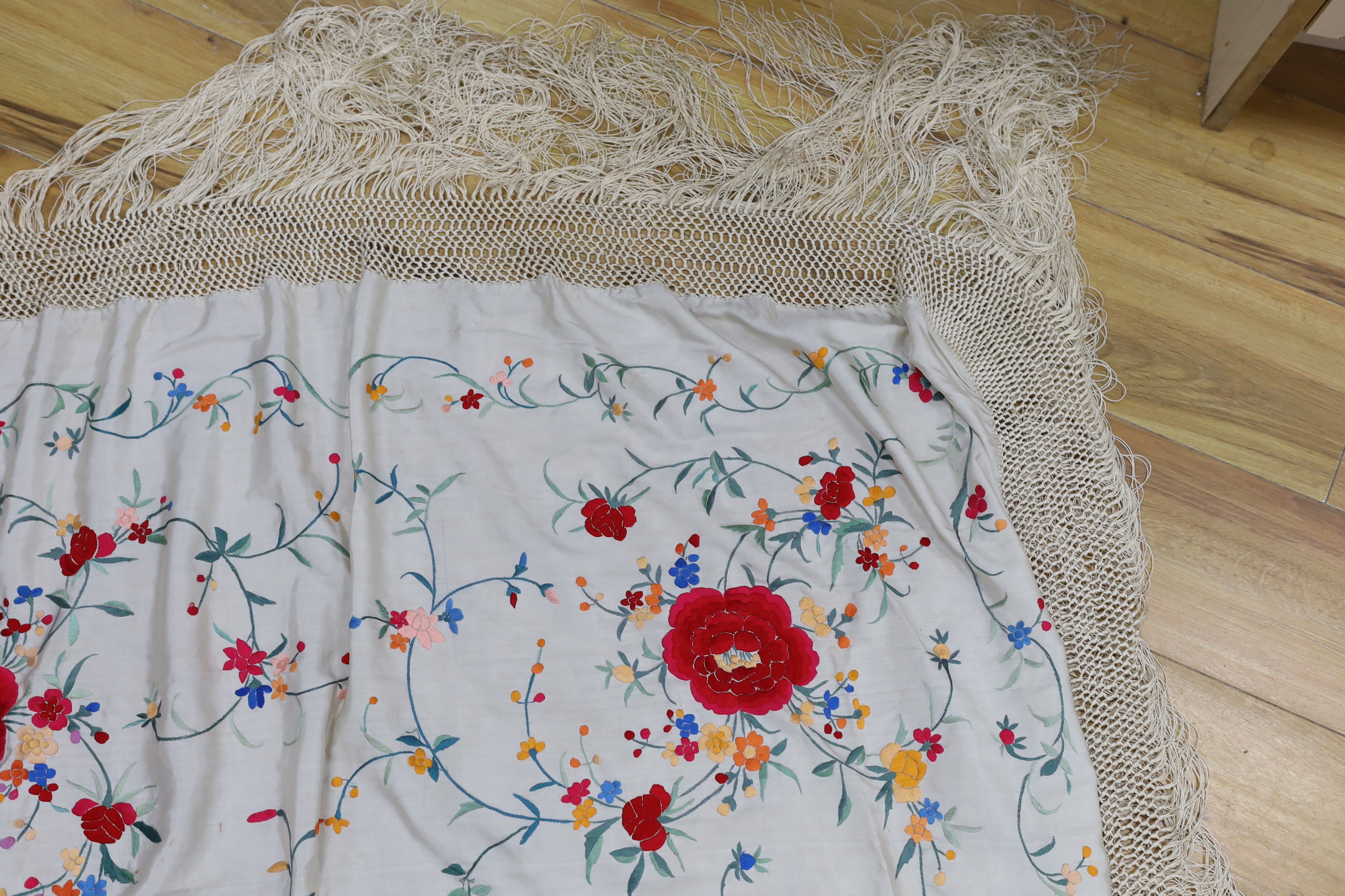 A Chinese cream silk polychrome embroidered shawl